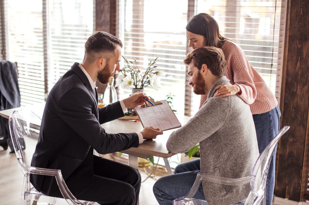 A young couple consulting with a business broker in Dallas for a possible business for sale.